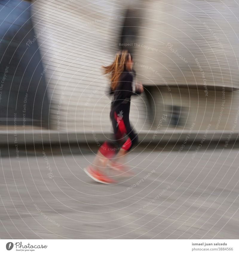 runner on the street in Bilbao city, Spain running marathon jogging action fitness health lifestyle person human sport exercise speed fast blur blurred motion