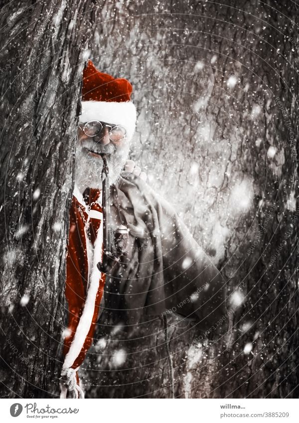 Santa Claus peeks out from behind snow-covered trees Pipe Eyeglasses Sack Facial hair Beard Gray-haired Coat Costume Tradition Santa's cap gifts Wishes