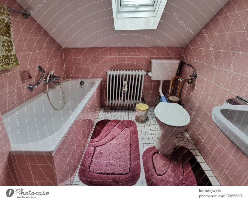 Old bathroom under the roof in old pink shades Bathroom Toilet Bathtub tiles Tile Pink Old building Cheap Rent Heater Sink Shower Sanitary Skylight Carpet