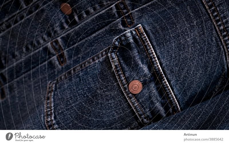 Selective focus on denim jean jacket pocket in clothes shop. Denim jacket pocket and button texture. Textile industry. Jeans fashion and shopping concept. Clothing concept. Denim jacket for sale.