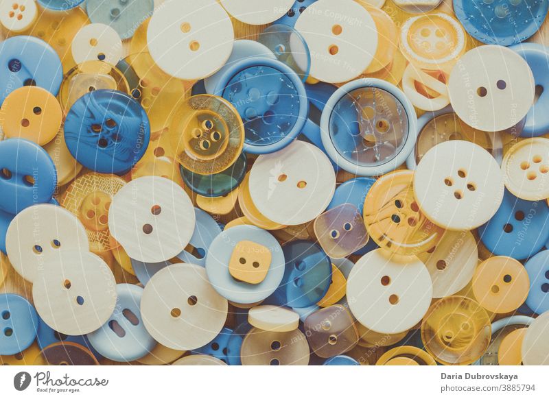 blue and yellow buttons colorful sew fashion round texture set design hobby circle clothing background closeup collection shape element sewing pattern