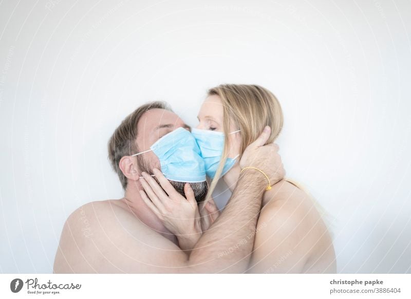Man and woman kiss with mask Woman Mask mouth-nose protection corona covid-19 COVID coronavirus pandemic Corona virus Protection Risk of infection Virus