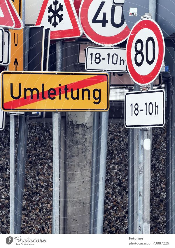 Sign forest - or many different traffic signs crowded close together. Road sign Many Signs and labeling Colour photo Exterior shot Deserted Transport Signage