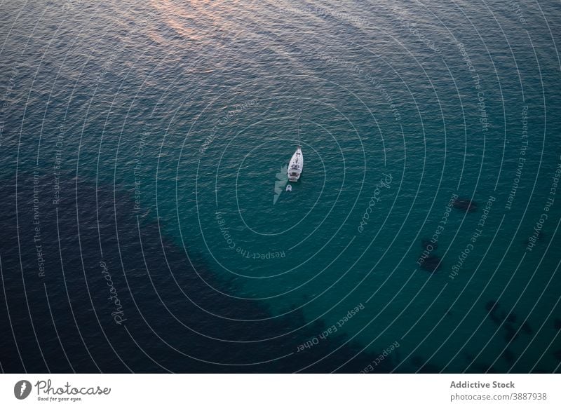 Floating boat with unrecognizable fisherman in rippling seawater - a  Royalty Free Stock Photo from Photocase