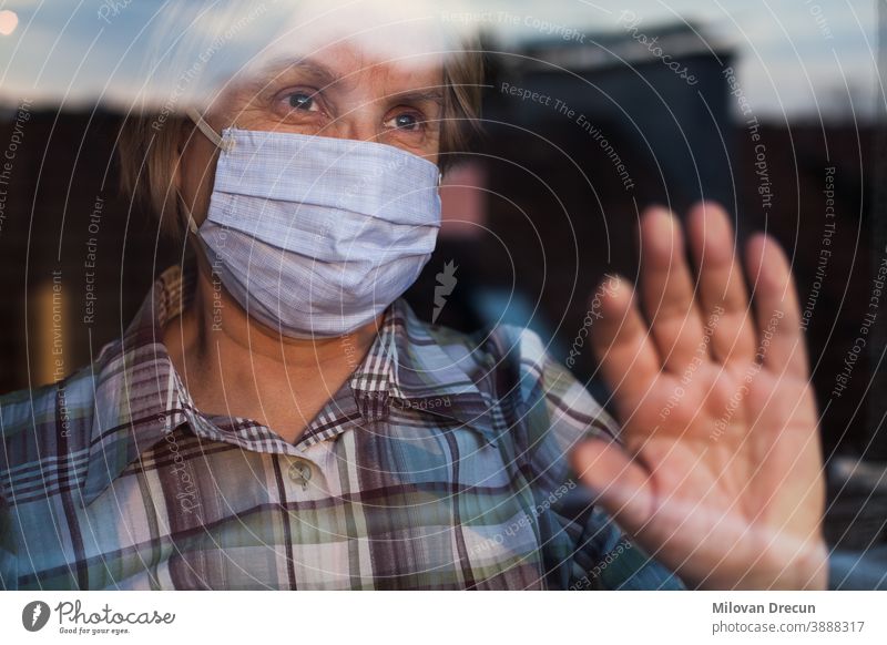Elderly caucasian woman wearing hand made protective face mask anxious care contagious corona coronavirus covid-19 crisis depressed depression disease epidemic