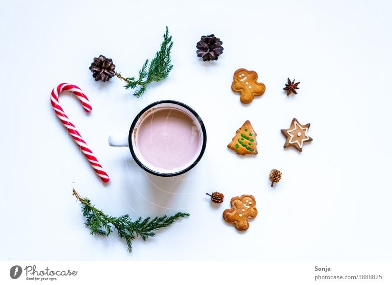 A cup of cocoa with gingerbread cookies and a candy cane on a white table Hot Chocolate Cup Hot drink Gingerbread Cookie Candy cane Christmas & Advent Tradition