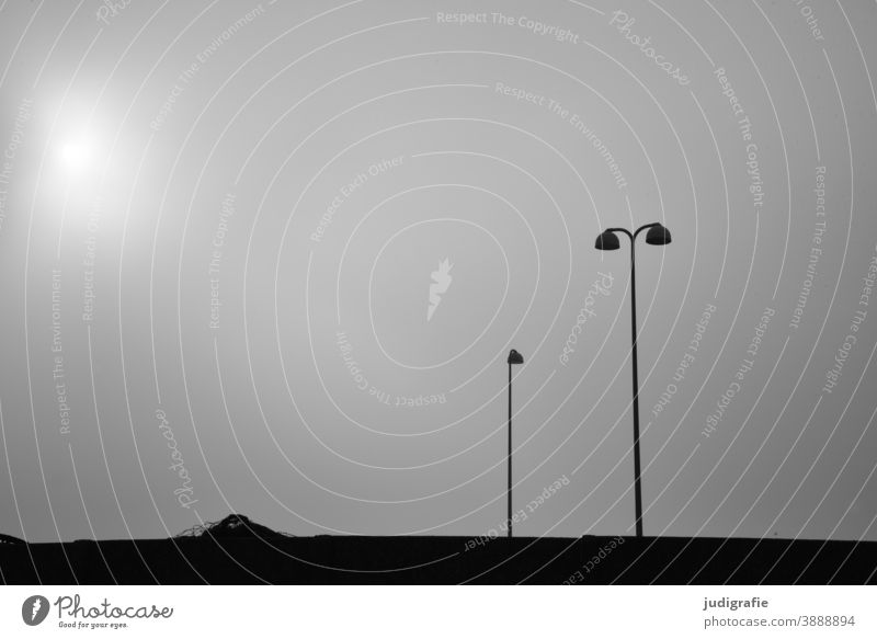 Minimalist harbour scene: street lamps against a misty sky streetlamp Lamp Street lighting Sky Harbour Wall (barrier) Minimalistic Black & white photo