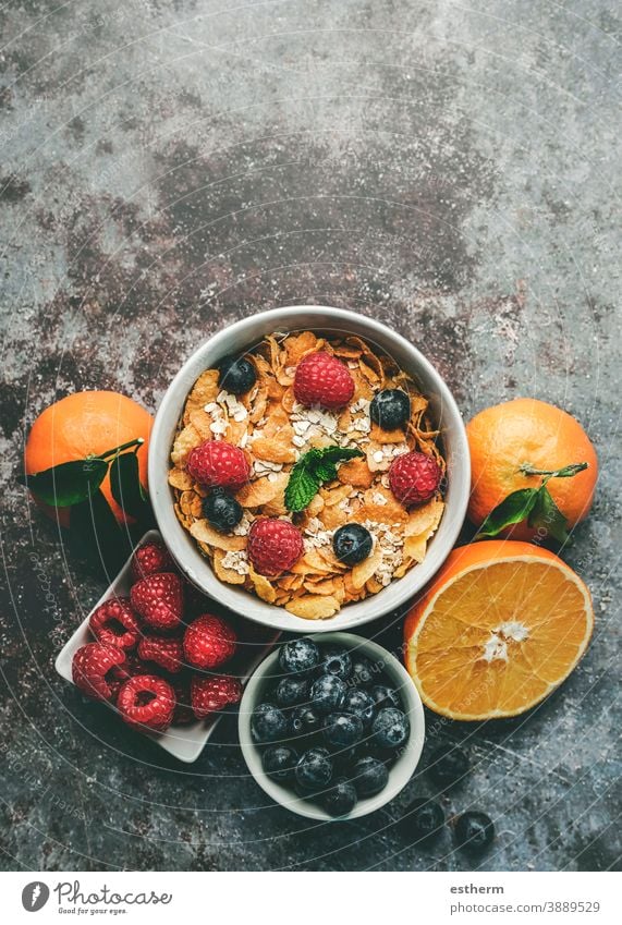 Healthy breakfast. Bowl with cereals, raspberries and blueberries next to oranges healthy breakfast raspberry fitness fruit nature freshness crunchy mint ripe
