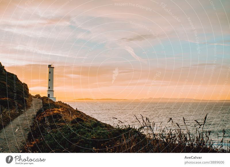 An horizontal shot of the white lighthouse during the sunset coast color image architecture ocean photography tourism outdoors sea lookout copy space scenic