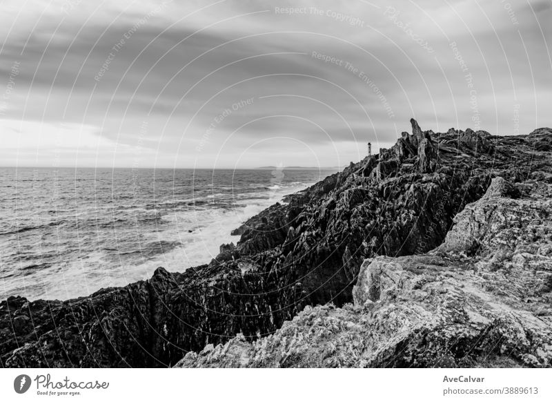 Black and white dramatic shot of the lighthouse on the broken coast of Galicia color image architecture ocean photography tourism outdoors sea lookout