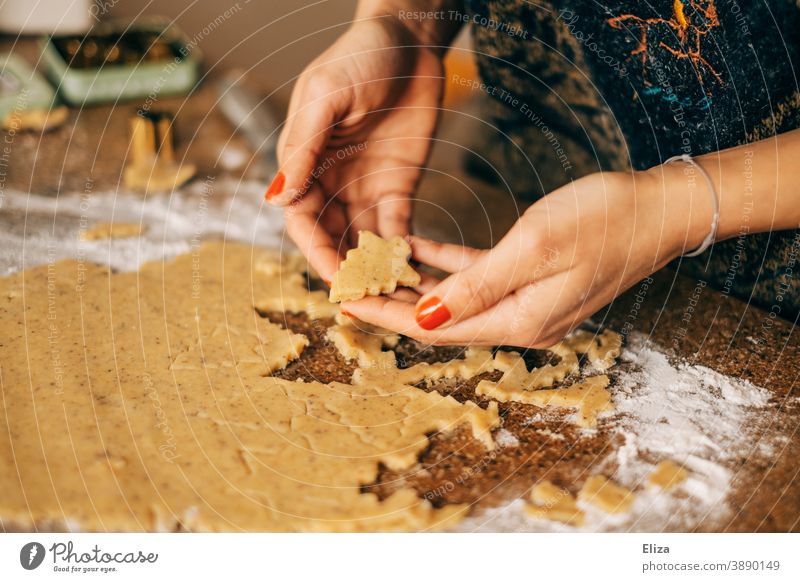 Christmas and Advent - A woman bakes Christmas cookies in the shape of a Christmas tree Christmas baking Cookie Baking fir trees bake cookies Christmas biscuit