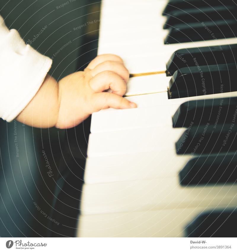 child hits the keys Child Piano Music Musical instrument Baby Toddler Culture Make music upbringing Parenting prosperity civilized Family luxury Hand Touch