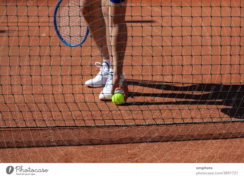 Tennis Player Taking a Ball from the Ground tennis player sportsman racket take ball court ground playground field clay competition activity service game set