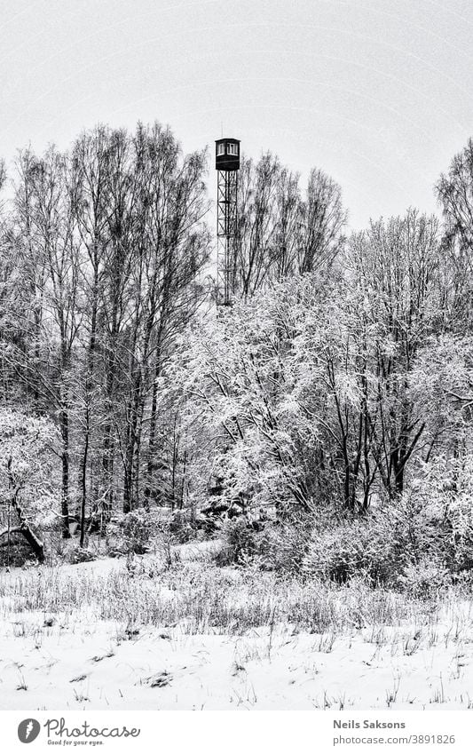 fire lookout tower in winter found in Latvian forest Architecture fireman camp cloud concentration Europe guard high landscape military nobody observation old