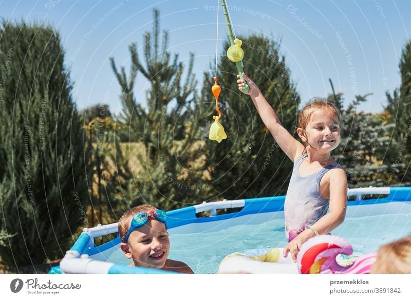 https://www.photocase.com/photos/3891842-children-playing-with-fishing-rod-toy-in-a-pool-in-a-home-garden-photocase-stock-photo-large.jpeg