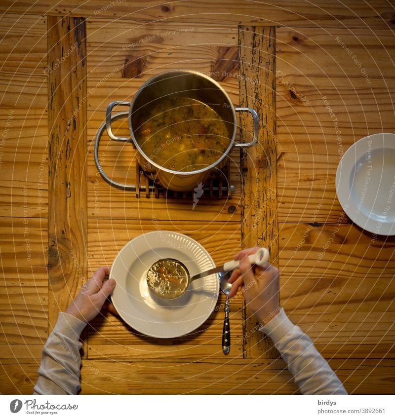 Pass out the soup, serve. Covered wooden table with soup pot, soup ladle, plate and spoons. Bird's eye view Soup Stew Plate Spoon Eating hands Arm Lunch