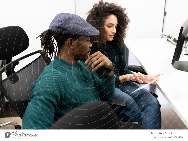 African American coworkers discussing business results in office colleague diagram casual positive together workplace african american black communicate