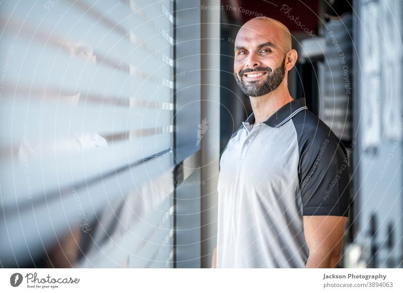 Portrait of confident, well built man at the gym trainer personal smile copy space bearded man businessman handsome modern instructor coach active adult athlete