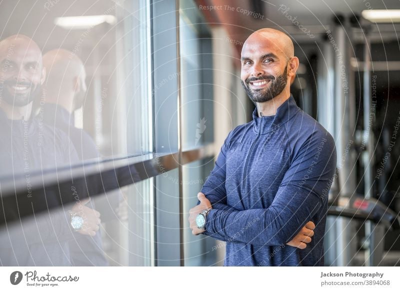 Portrait of confident, well built man at the gym trainer personal smile copy space bearded man businessman handsome modern instructor coach active adult athlete