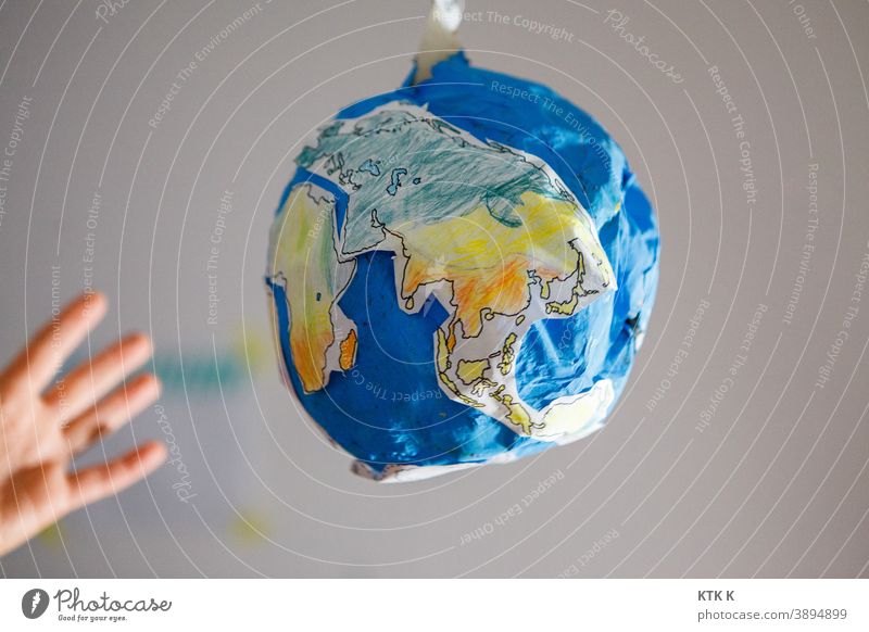 The world within reach; cardboard world earth Cardboard model earth papier mâché Model model building scale Fraud Hand Grasp ocean Continents Blue Water Earth