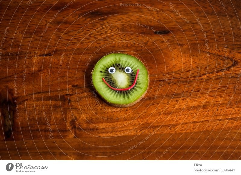 A slice of kiwi with a smiling face - Healthy nutrition Kiwifruit salubriously vitamins Face laughing Vitamin C Fruit Nutrition Vitamin-rich Fruity Funny