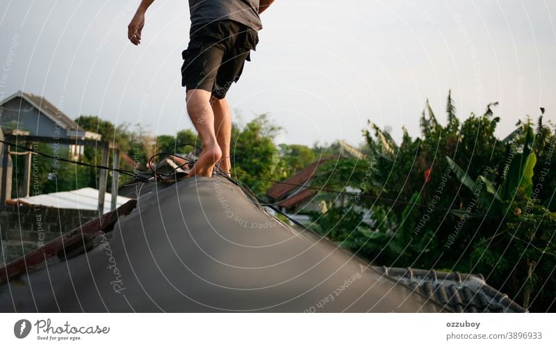 man walking on the rooftop Man Walking Youth (Young adults) Roof Exterior shot Human being Masculine Day 1 18 - 30 years Colour photo Shallow depth of field