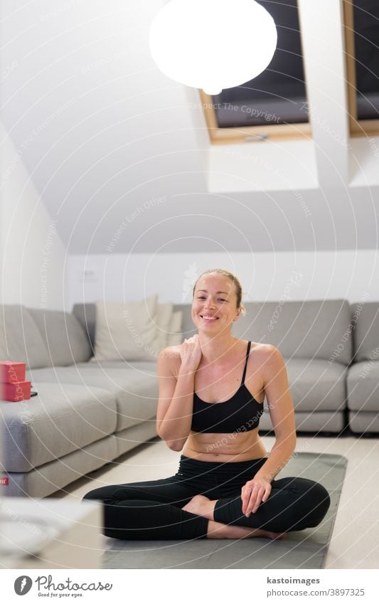 Beautiful blonde woman doing home workout indoors. Woman practice