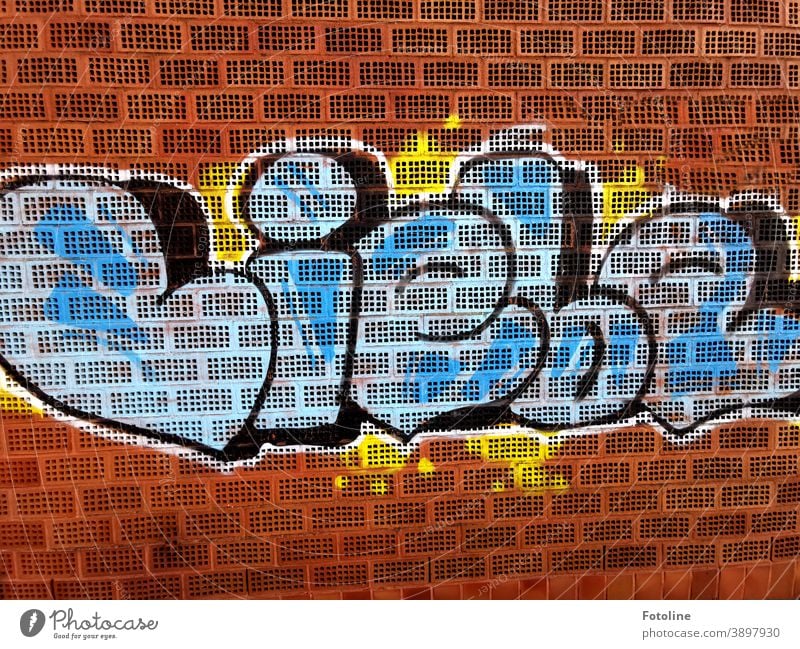 All that counts - or a graffiti with the word "love" sprayed on a brick wall Graffiti Brick Brick wall Brick facade Bricks Colour colored Facade Exterior shot