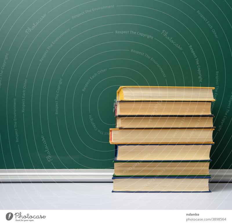 blank green chalk school board and stack of books, back to school bookshop bookstore chalkboard archive background classroom closed collection college cover