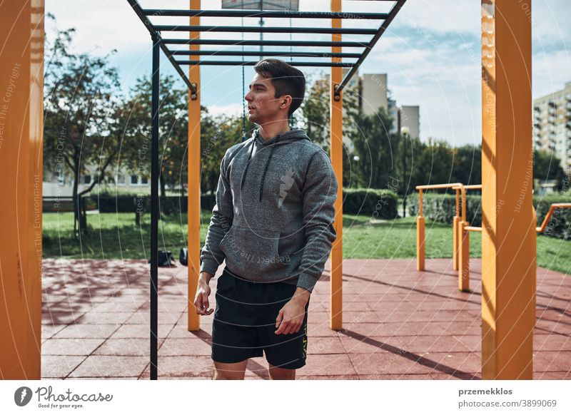 Young man bodybuilder having break during his workout in a modern calisthenics street workout park care caucasian health lifestyle male one outdoors person