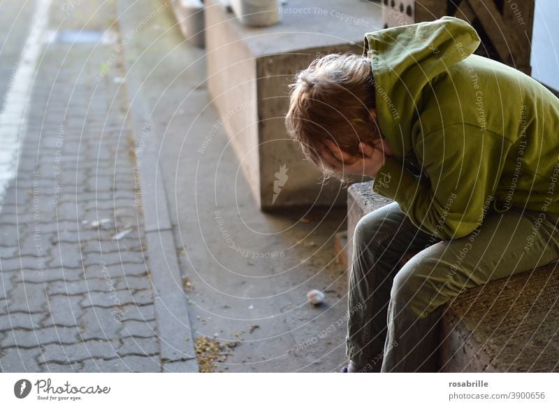 Life breaks | little boy sits desperately crying with his hands in front of his face in an underpass sad Child Boy (child) Cry by oneself Grief Concern Fear