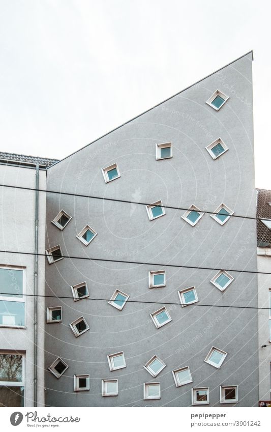 many twisted windows on a house facade Window Window pane Window board Shutter Window frame Glazed facade Window seat View from a window Windowsill Colour photo