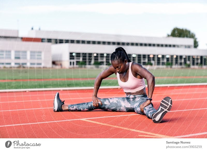 Athlete sprinter stretching her legs control race run competition athlete athletics competitive ready line beginnings compete competitor olympic olympics sports