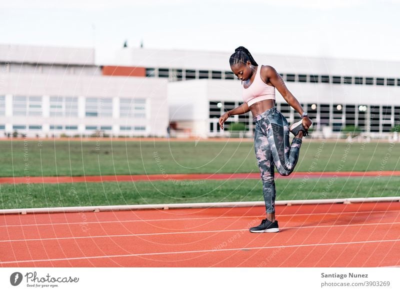 Athlete sprinter stretching her legs control race run competition athlete athletics competitive ready line beginnings compete competitor olympic olympics sports