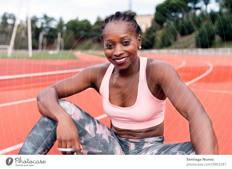 Afro athlete woman flexing and showing muscles. Stock Photo by megostudio