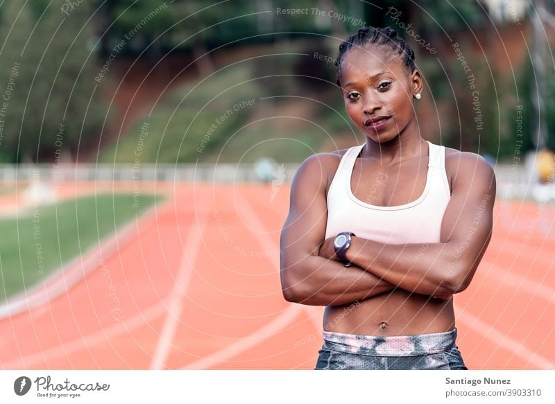 A strong athletic running female athlete on a - Stock