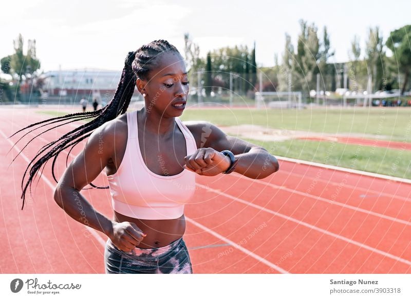 Athlete sprinter watching the clock while running control time timing race competition athlete athletics competitive ready line beginnings compete competitor