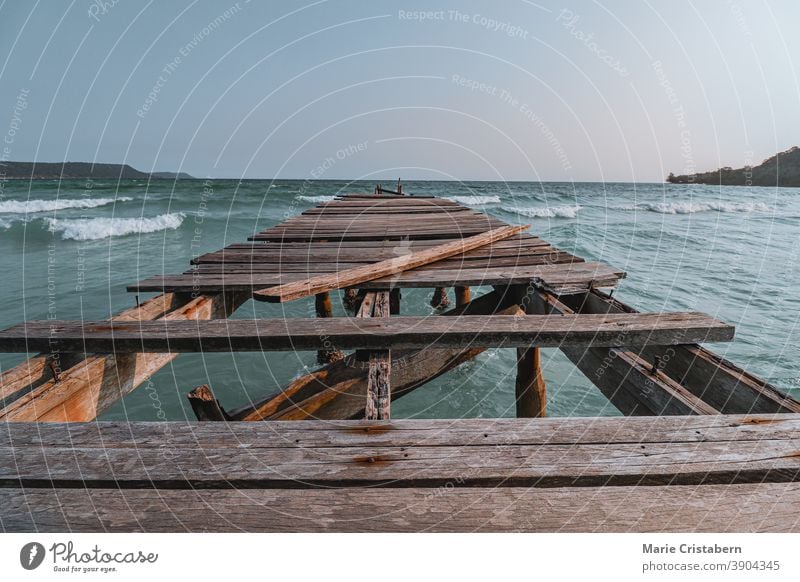 Conceptual photo of a broken wooden pier showing concept of the importance of supporting mental health, social isolation and social distancing during the covid-19 pandemic