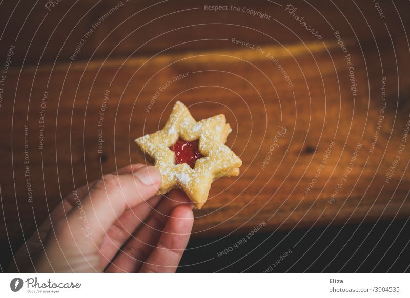 Woman holding a rogue star-shaped cookie Cookie nibble Christmas Christmas cookies Christmas treats Christmas & Advent Baked goods cute Hand feminine
