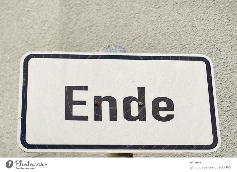 the white, framed metal sign reads "End" in black block letters / conclusion ending metal plate Target Completed Communication beginning of the end Prelude