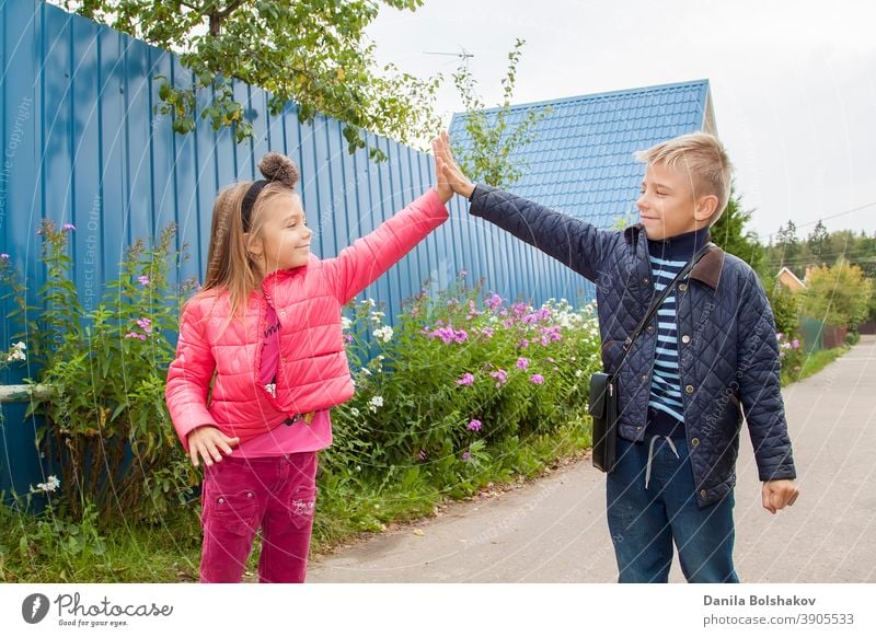 high five. Happy children greet each other outdooes. Image with selective focus nature person boy smiling emotion holiday vacation sunny lifestyle healthy