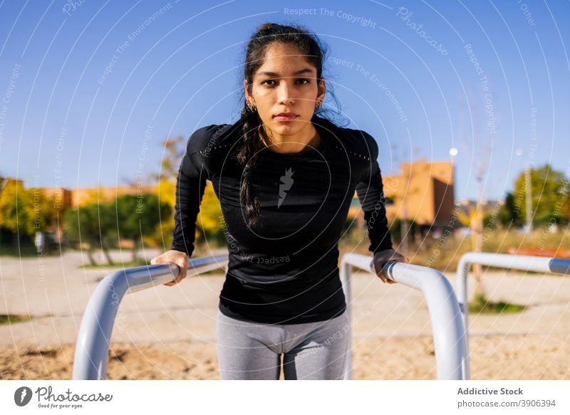 Confident fit woman in sportswear standing near post doing warmup exercise  before playing basketball on court - a Royalty Free Stock Photo from  Photocase