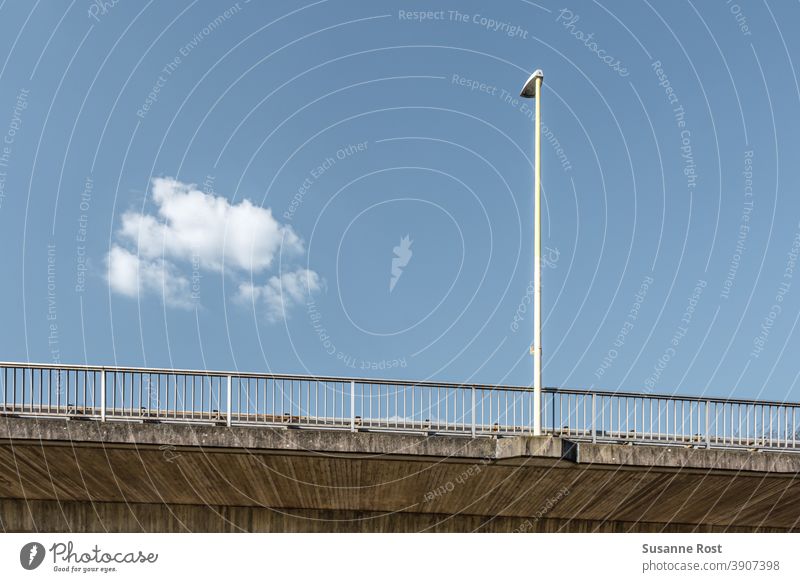 Lamppost and bridge railing on a bridge. The sky is blue, there is only one cloud. Bridge Bridge railing Architecture Day Sky Blue Lantern Clouds Cloudless sky