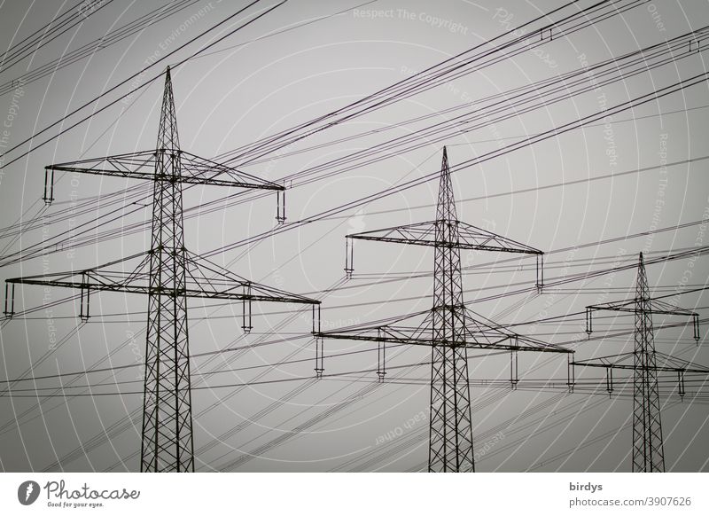 Power pylons with high voltage line in cloudy weather Power poles High voltage power line Electricity Energy industry Electricity pylon power supply Cable Fog