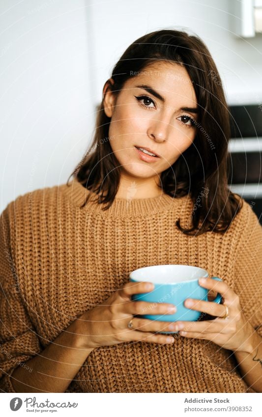 Woman with cup of beverage relaxing in kitchen woman coffee home tranquil drink enjoy domestic weekend female mug chill calm apartment cozy peaceful hot drink