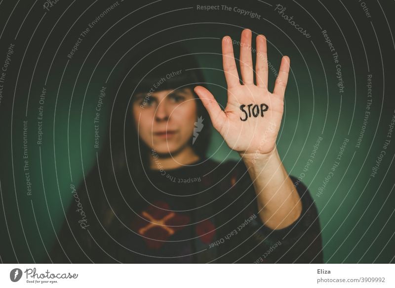 Woman Stretches Out Her Outstretched Hand On Which The Word Stop Is Written Into The Camera Saying No Showing Boundaries A Royalty Free Stock Photo From Photocase