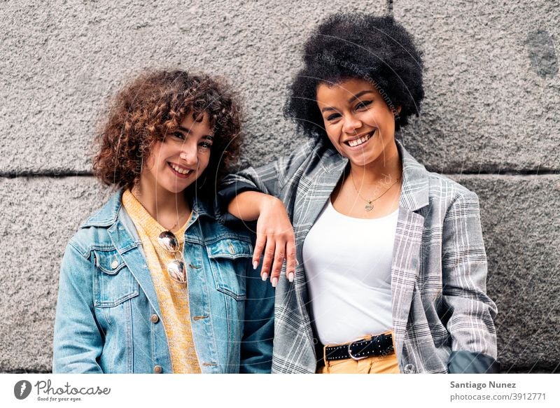 Cool Afro Girl and Friend Smiling women looking at camera street multi-ethnic afro girl caucasian portrait having fun front view friends friendship multiethnic