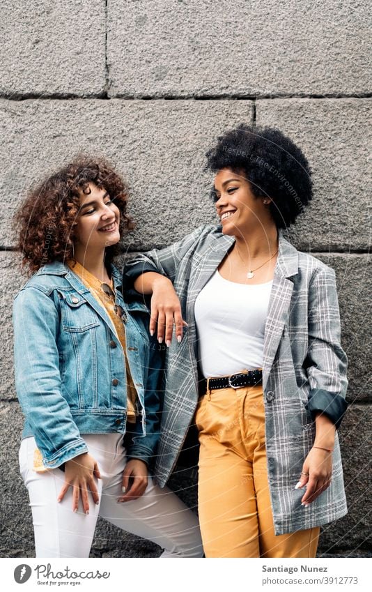 Cool Afro Girl and Friend in Street women looking at each other street multi-ethnic afro girl caucasian portrait having fun front view friends friendship