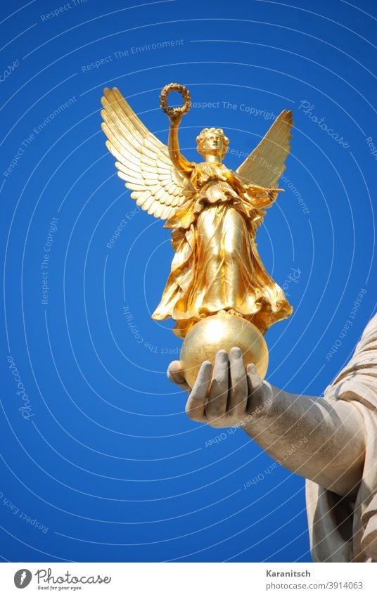 Golden Nike in the hand of Pallas Athena. golden Goddess of victory Figure laurel wreath Grand piano Hand stop Statue Sky Blue clear Vienna Parliament