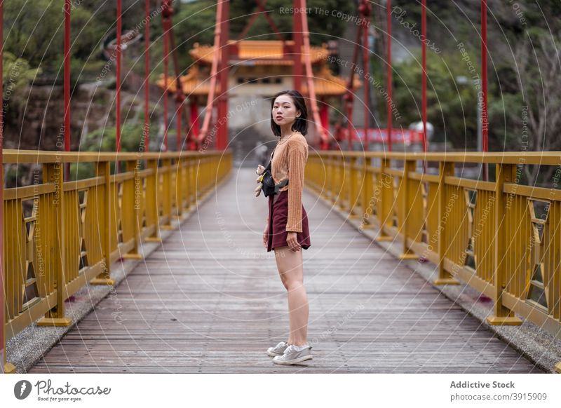 Ethnic woman standing on bridge enjoy vacation travel traveler suspension summer female ethnic asian hualien city taiwan wooden young holiday positive relax